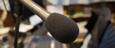 Photograph of a Reader speaking into microphone